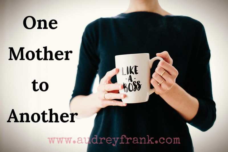 One mother to another is holding a cup that says "Like a Boss"
