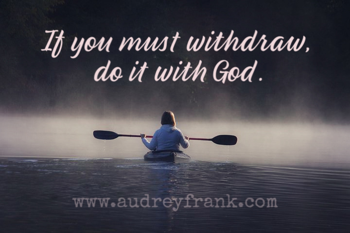 A picture of a person on a kayak in the early morning as mist rises from a lake. The words, "If you must withdraw, do it with God," describe the subject of the post.

