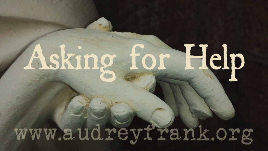 A statue of helping hands with the words asking for help describing the subject of the post