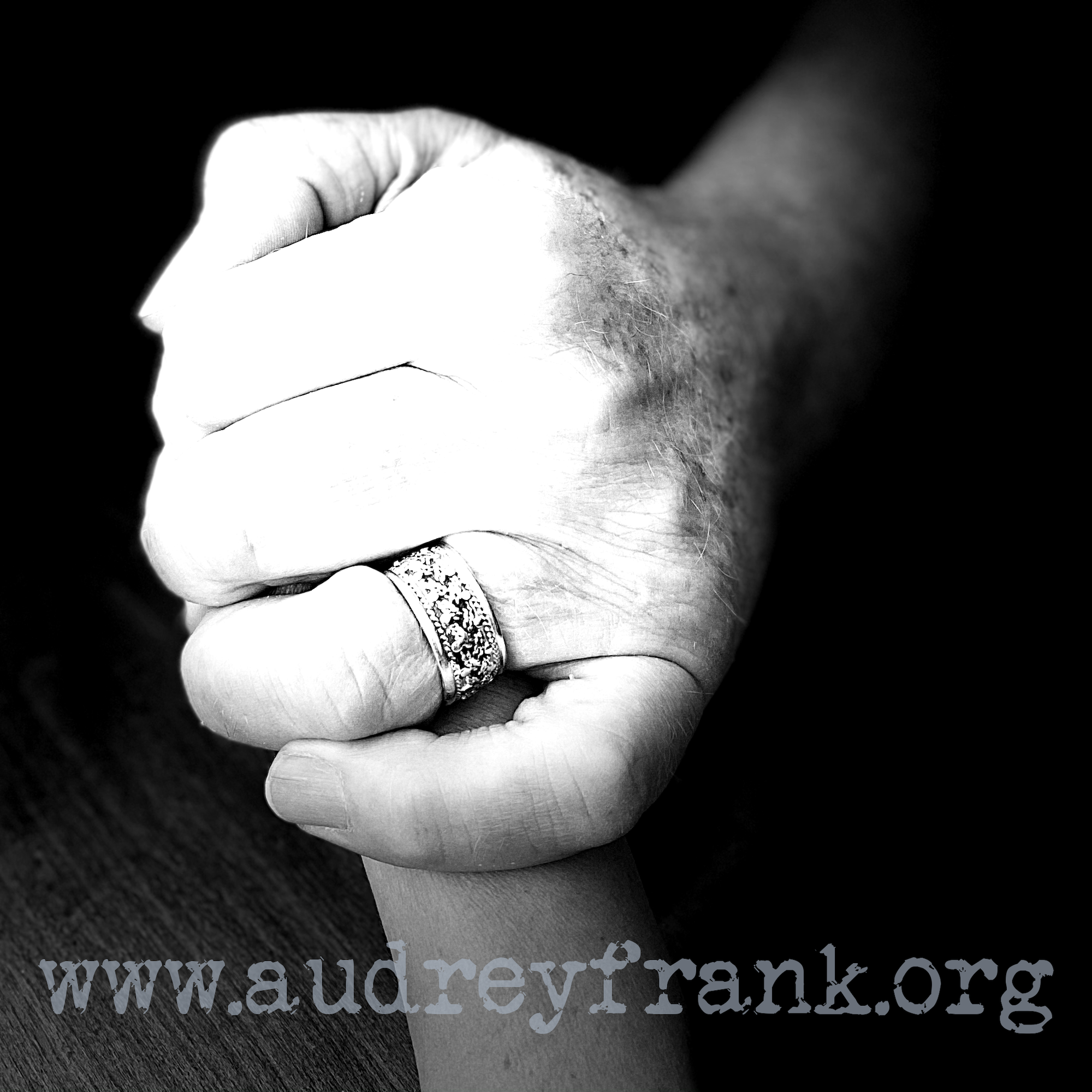 A father's hand holding a daughter's hand to illustrate the topic of the post "My Father's Hands".