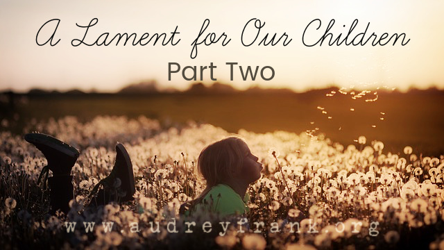 A little girl blowing dandelions in a field with the words, "A Lament for Our Children Part Two" describing the subject of the post.