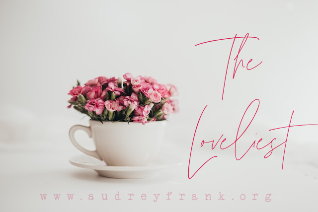 Flowers in a teacup with the words "The Loveliest"