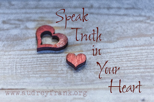 Wooden cut-out hearts against a wood background with the words Speak Truth in Your Heart describing the subject of the post.