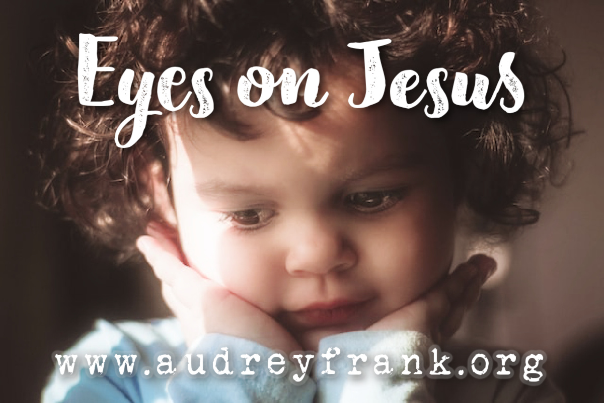 Close up of a child's face with the words, "Eyes on Jesus" describing the subject of the post.