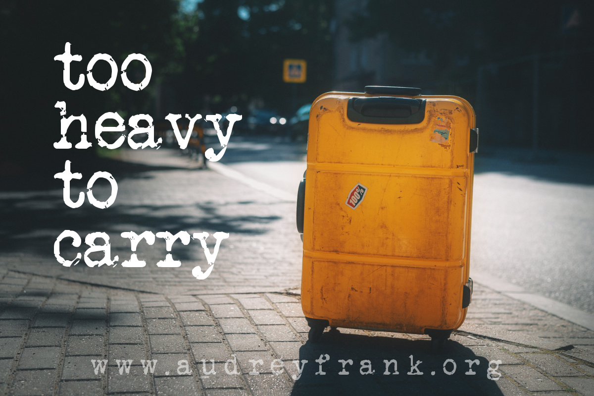 a battered suitcase with the words "Too Heavy to Carry" describing the subject of the post.