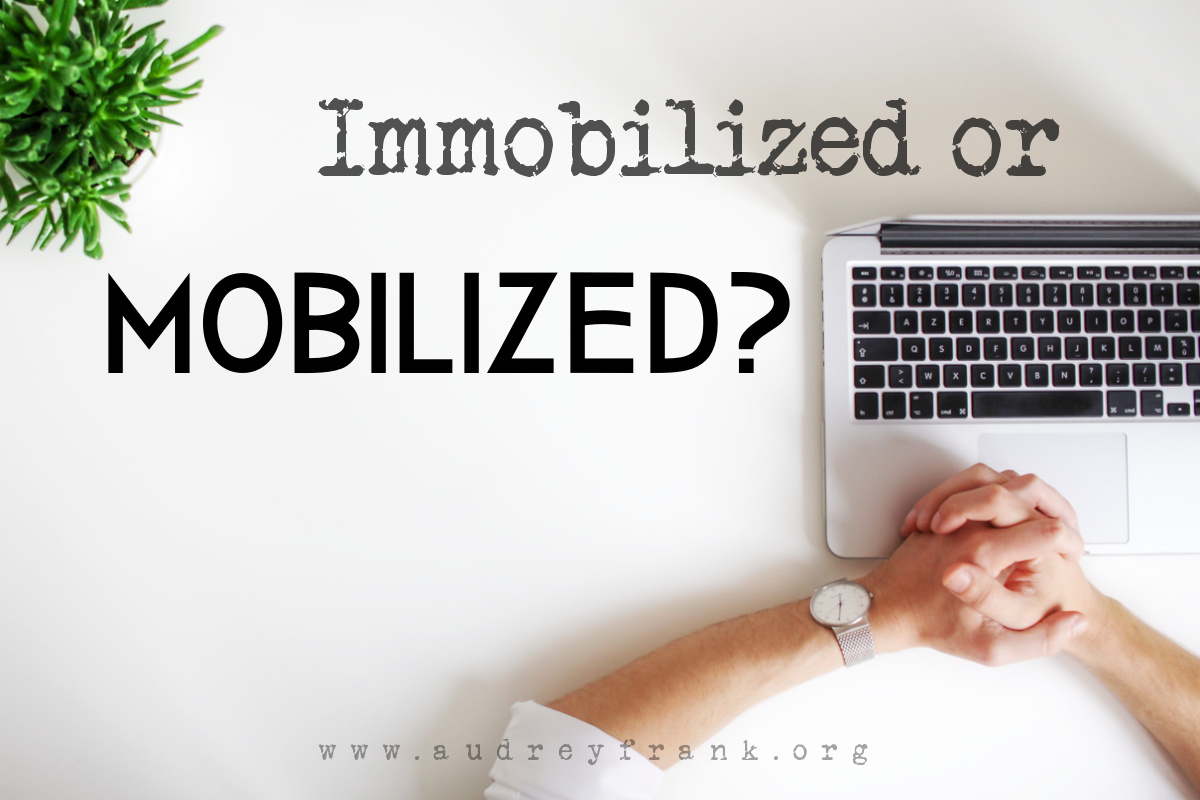 Person sitting at work desk with words "Immobilized or Mobilized" describing the subject of the post.