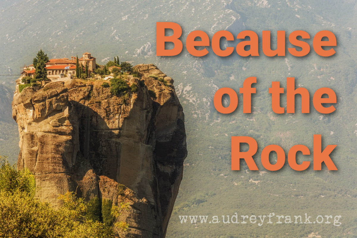 A rock mountain with buildings on top and the words "Because of the Rock" to describe the subject of the post.