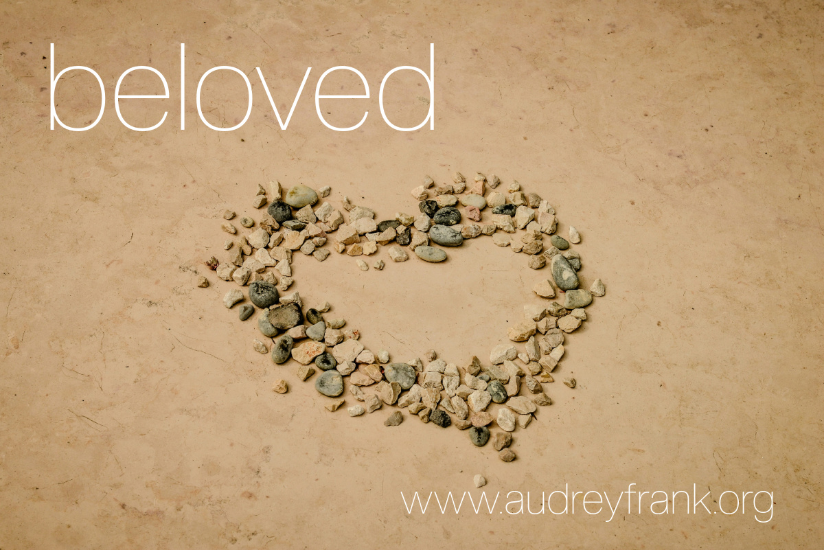a heart shape created from stones on a beach with the word "beloved" describing the subject of the post.