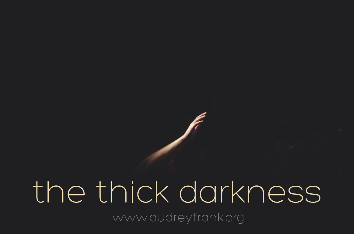 a hand reaching out in the dark, with the words "Thick Darkness" describing the subject of the post.
