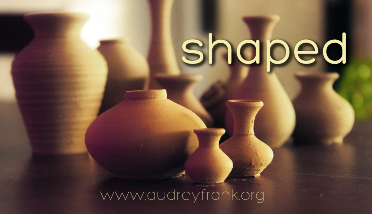 a group of differently shaped clay vessels and the word "shaped" describing the subject of the reflection.