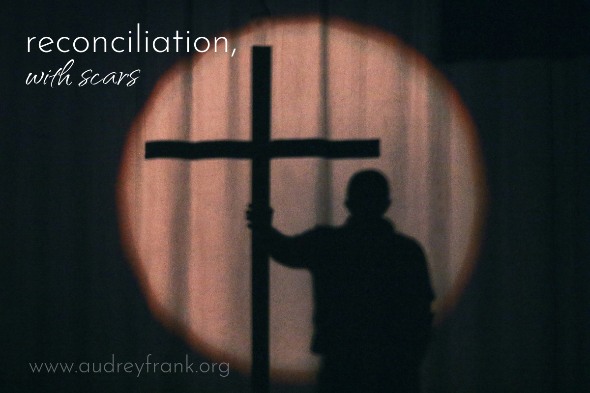 a silhouette of a person holding on to a cross with the words, Reconciliation, with Scars, describing the subject of the post.